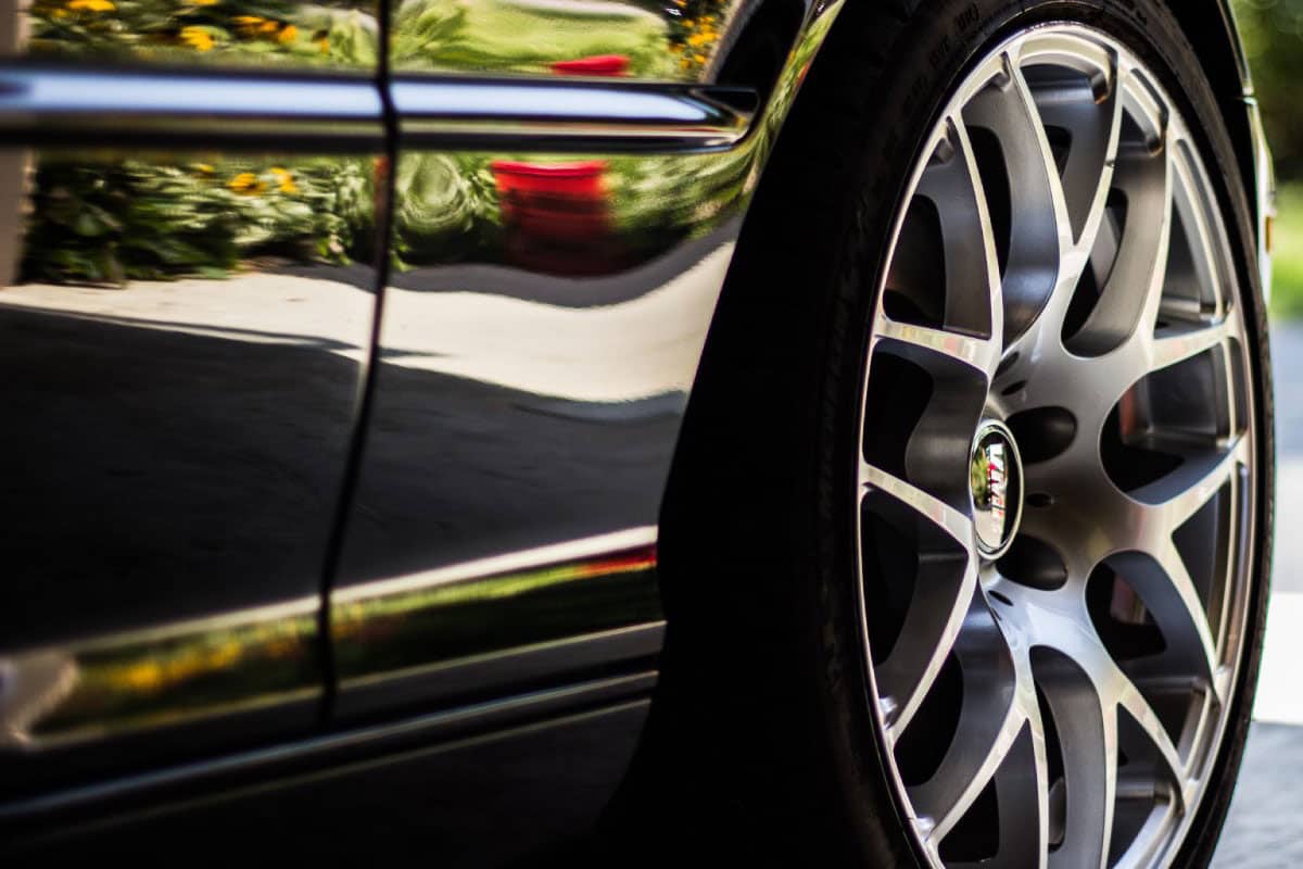 Close up of a car door and back tire after paintless dent repair.