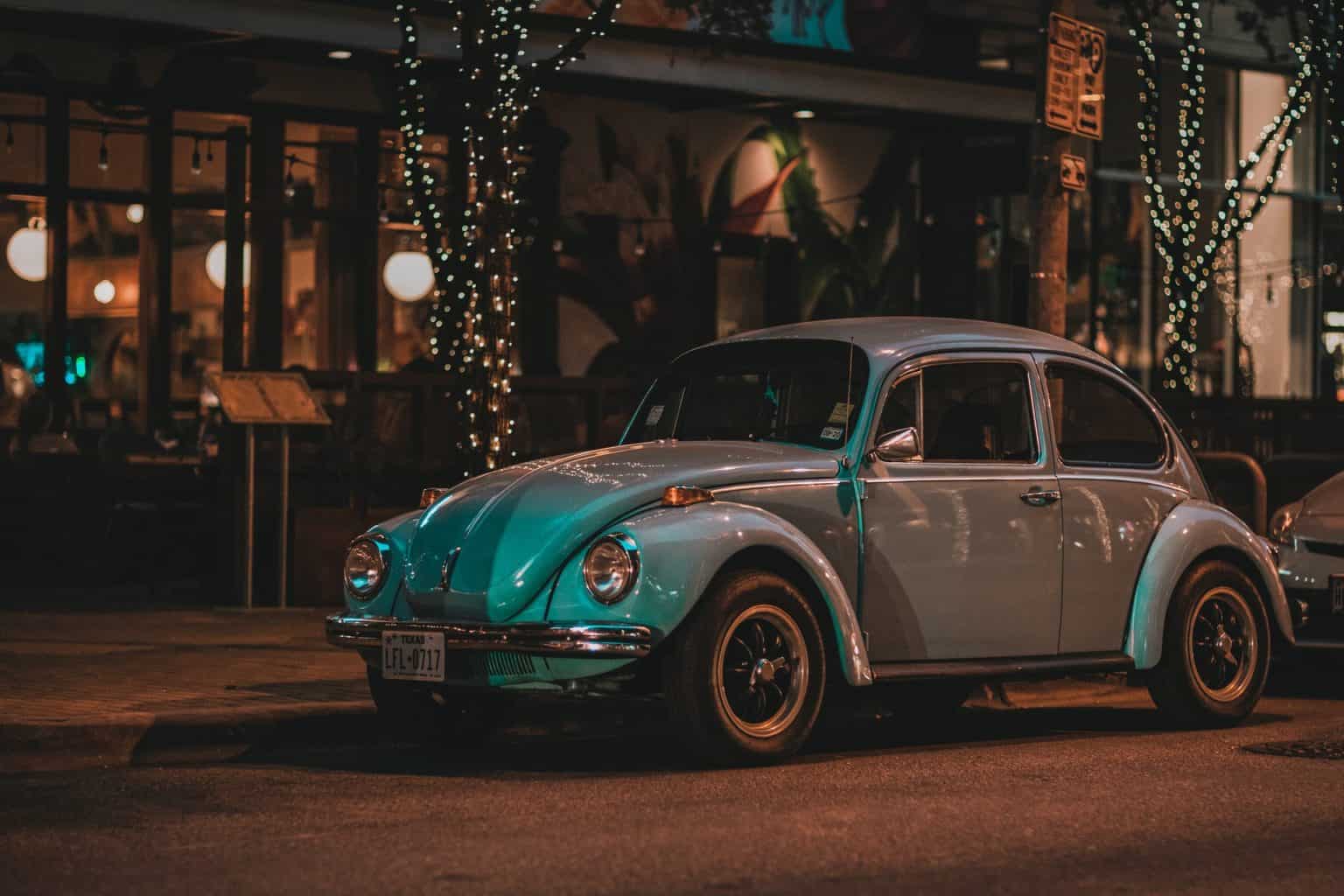 A Volkswagen Beetle parked on the side of the street.