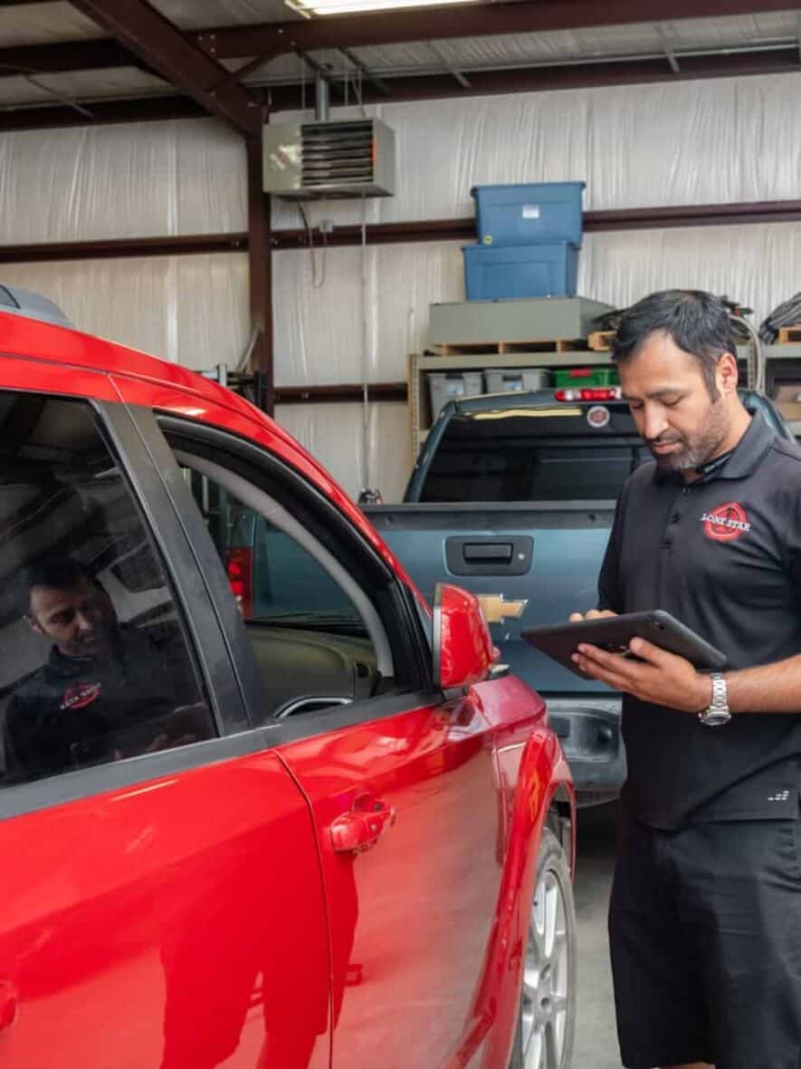 A PDR technician assessing a car for door ding repair in Georgetown.