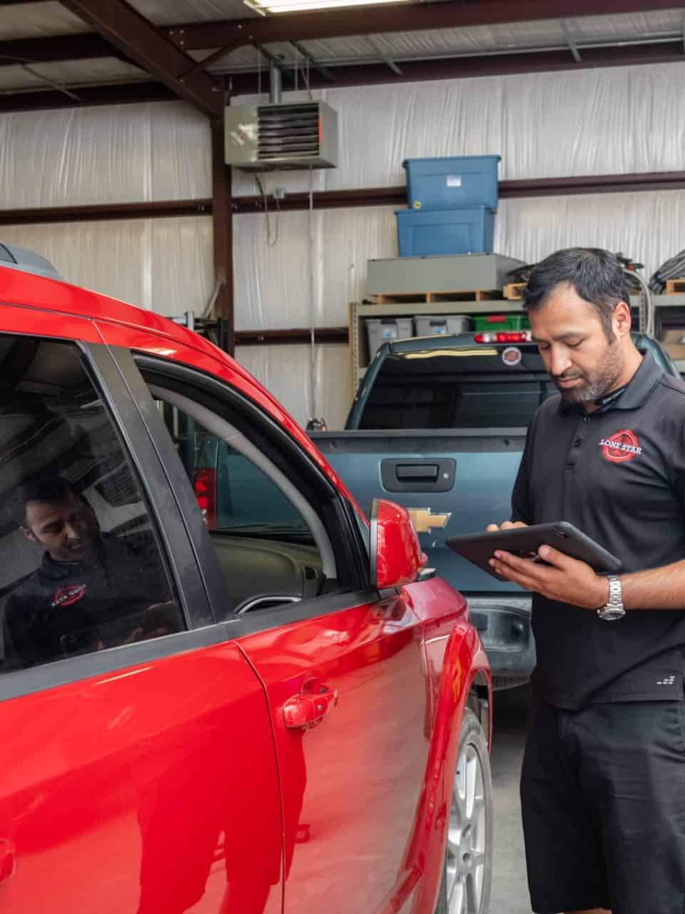 A PDR technician assessing a car for door ding repair in Georgetown.