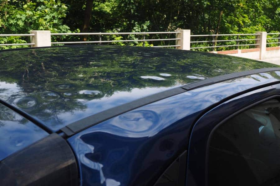 blue car with hail damage that needs paintless dent repair for removal of dents in Austin, TX (PDR)