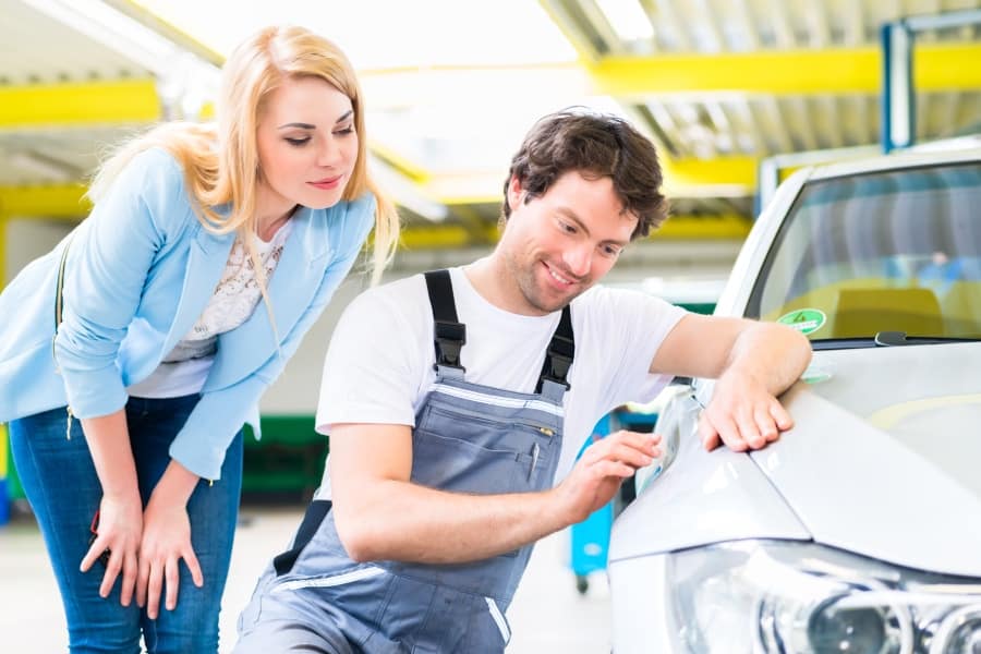 happy customer looking at professional man doing local dent repair in Round Rock