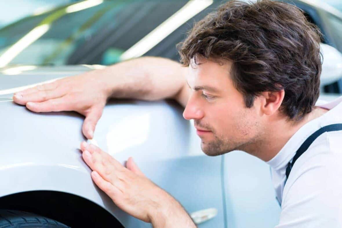 Professional repairing a little dent on a car