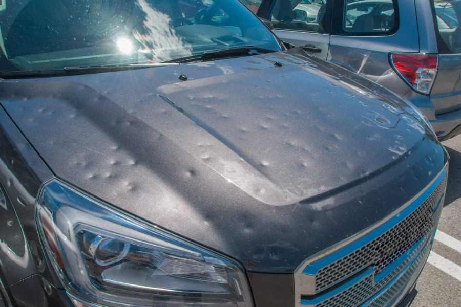 A car hood with hail damage needing Elgin PDR services.