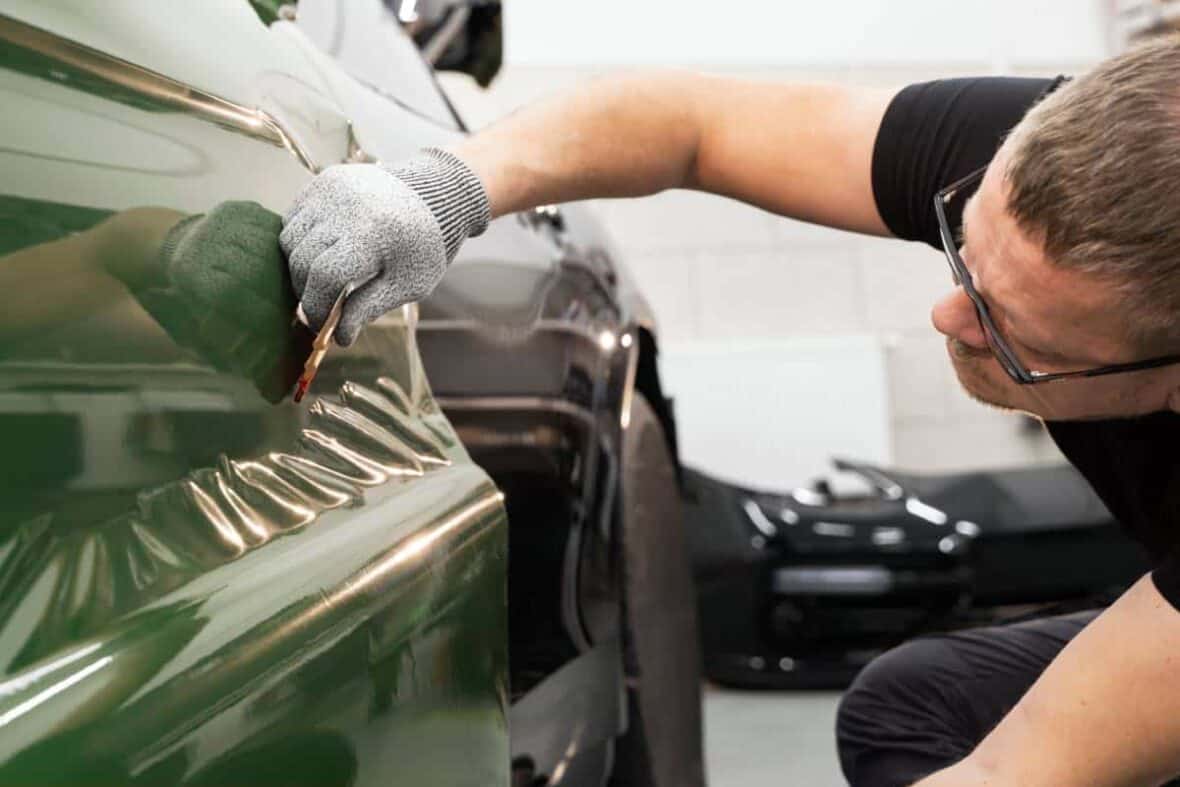 A technician performing Austin paintless dent repair for fleet vehicles.