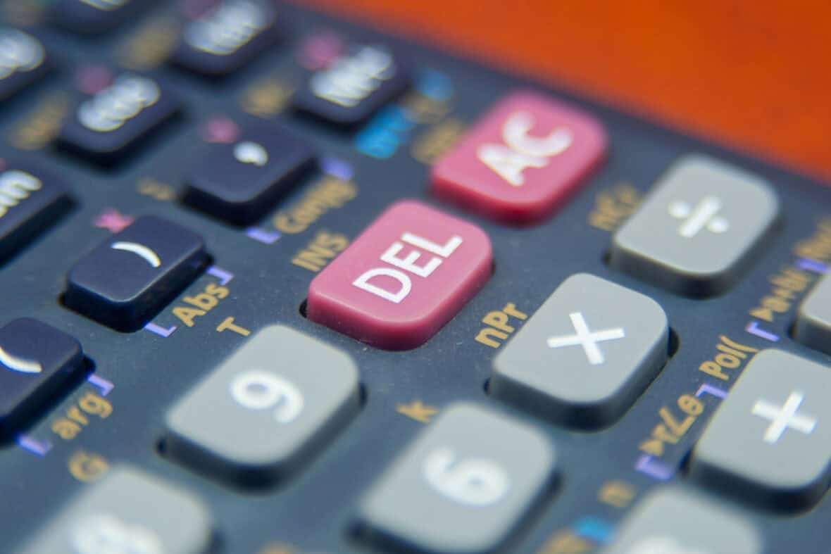 A calculator sits against a red background.