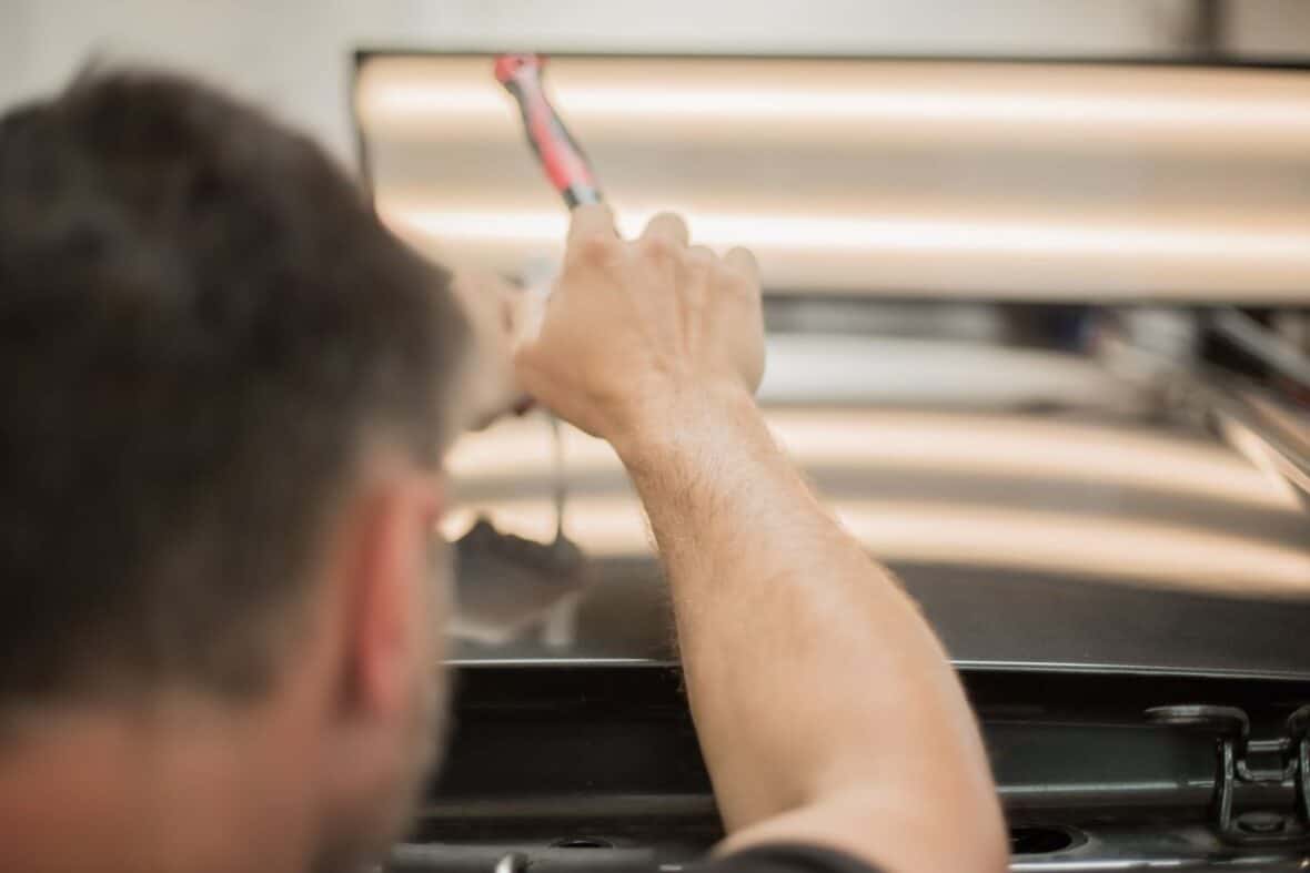 A PDR specialist removing dents from a car.