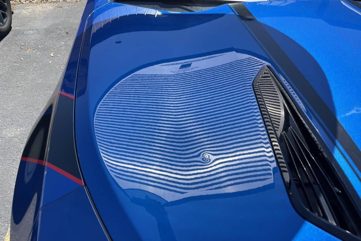 Car covered with protective hail blanket to prevent storm damage