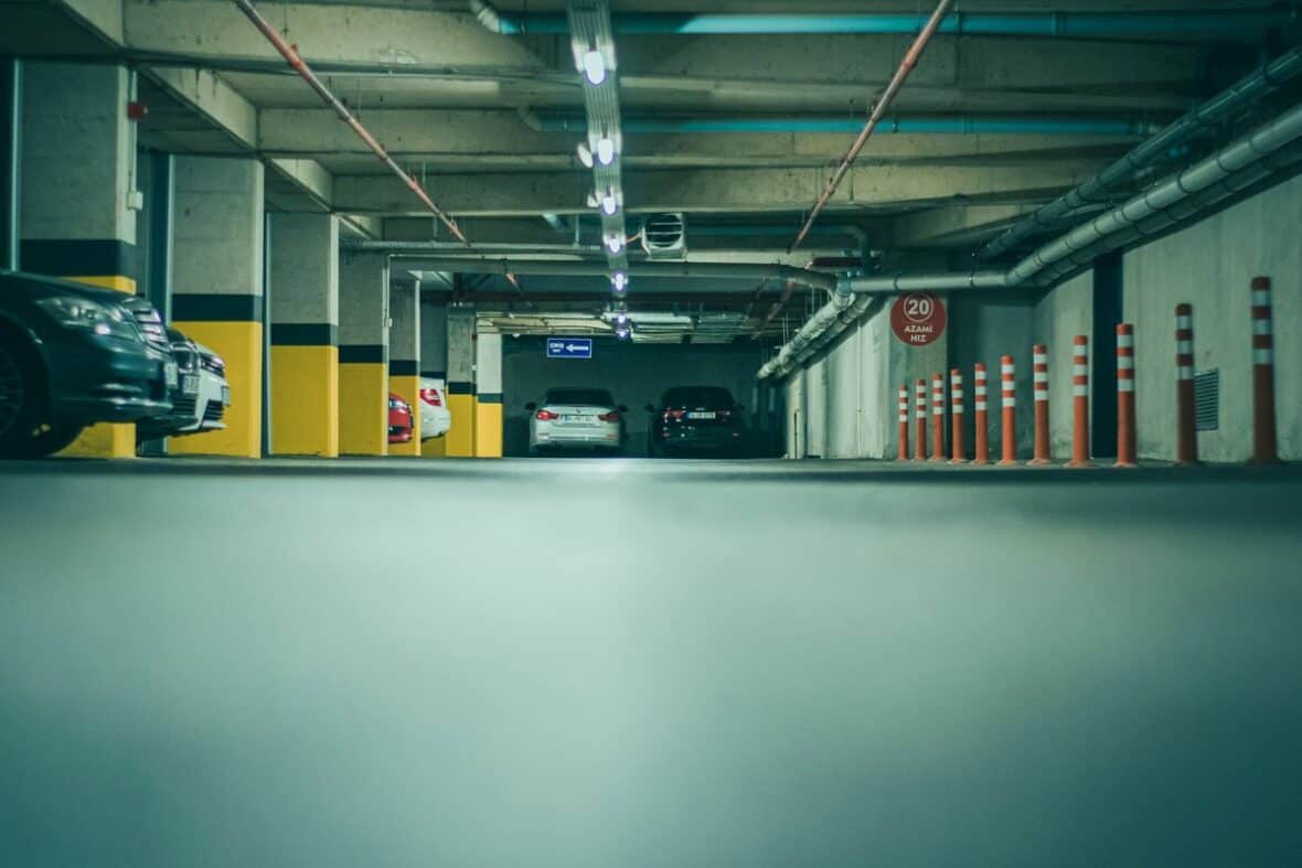 Cars parked in a tight parking garage where door dings commonly happen