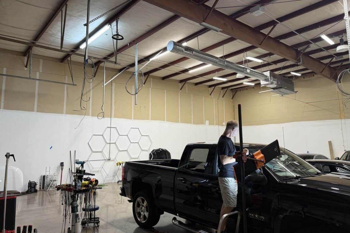 Pickup truck body panel being assessed for paintless dent repair